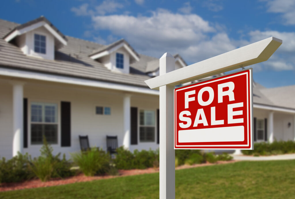 For Sale Real Estate Sign in Front of a Home