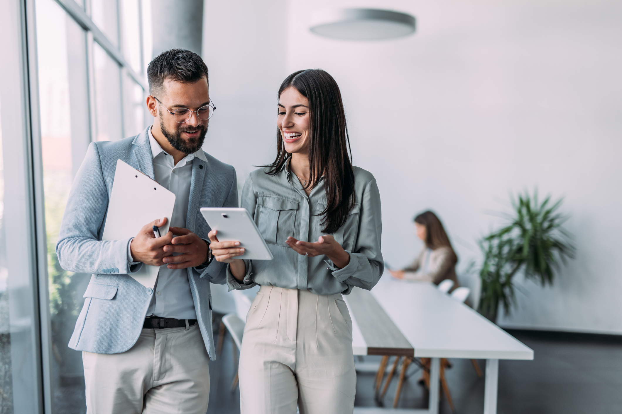 two confident business persons talking in the work place